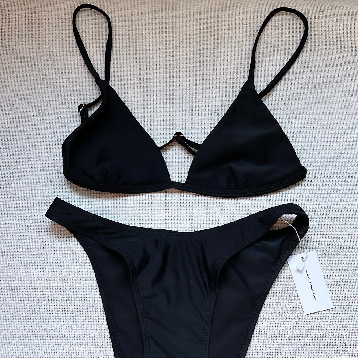 Seamless Black triangle bikini top with adjustable shoulder and back straps with gold sliders.