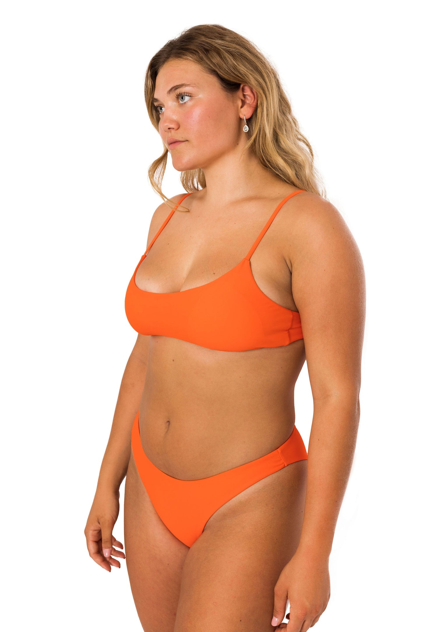 Orange high-cut seamless bathing suit bikini bottom with the perfect amount of cheeky coverage in orange. Equally flattering as comfortable.